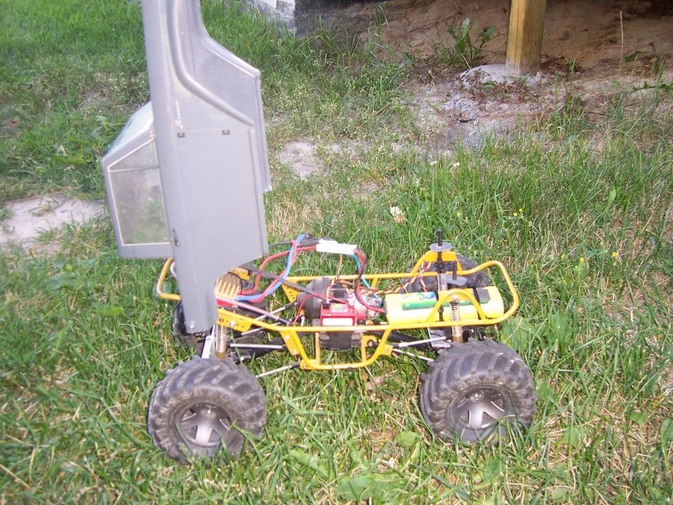 Yellow remote control monster truck chassis with open body and visible electronics