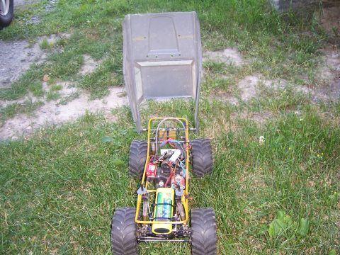 1996 Ford Bronco - RC buggy chassis and body shown separately outdoors on grass.