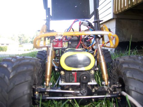 1996 Ford Bronco - This remote control monster truck has a yellow roll cage and gold-colored shocks.