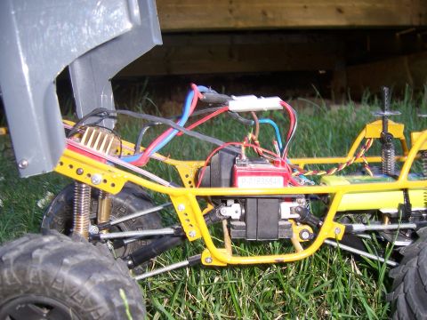 1996 Ford Bronco - Close-up of a remote control car's chassis, showing the battery and electrical wiring.