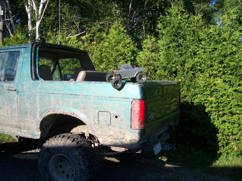 1996 Ford Bronco - A teal 1996 Ford Bronco is seen from the rear, with a small toy truck placed on its tailgate.