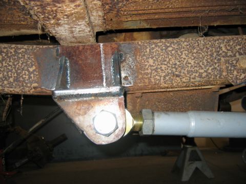 1992 Ford Mustang - Close-up view of a custom-fabricated suspension component on a vehicle's undercarriage.