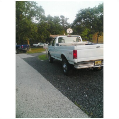 2004 Jeep Wrangler - This 1997 Ford F-250 pickup truck is seen from the rear, equipped with a toolbox and a basketball hoop mounted on the cab.