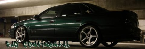 1993 Ford Taurus - This 1993 Ford Taurus SHO Continental sedan features a dark green paint job and aftermarket wheels.