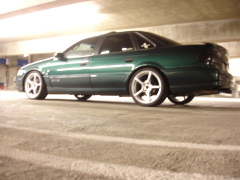 1993 Ford Taurus - A green sedan is parked in a dimly lit parking garage.