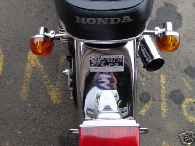 1985 Ford Crown Victoria LTD - Rear view of a Honda motorcycle fender, showing turn signals and a license plate bracket.