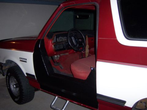 1991 Ford Bronco - Interior view of a 1991 Ford Bronco, highlighting the red upholstery and dashboard details.