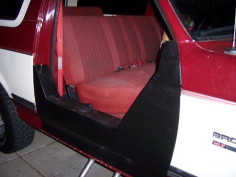 1991 Ford Bronco - Interior view of a 1991 Ford Bronco, highlighting the red seats and the removed half door.