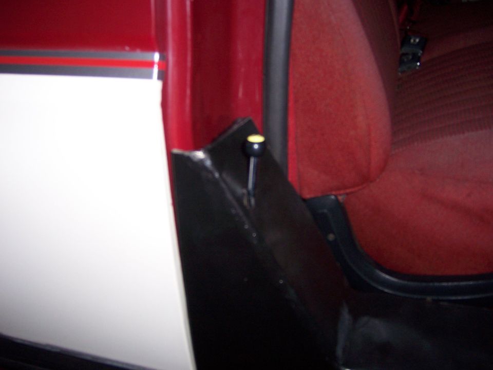 1991 Ford Bronco interior showing red seat fabric and part of the door panel