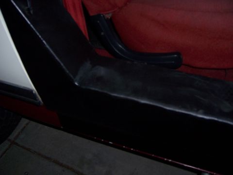 1991 Ford Bronco - Interior view of a 1991 Ford Bronco, showing the door panel and red upholstery.