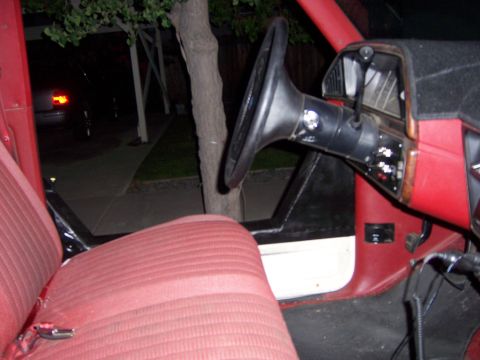 1991 Ford Bronco - Interior view of a red vehicle, showing the seat, steering wheel, and dashboard details.