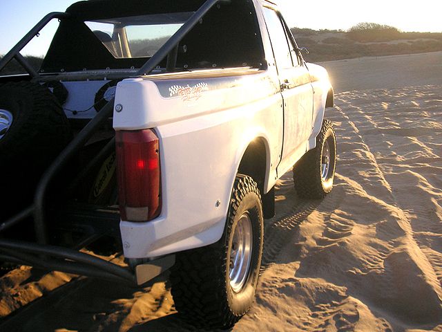 1996 Ford Bronco prerunner with roll cage on sand dunes