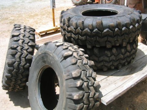 1973 Ford F-100 - A collection of off-road tires are displayed on a wooden platform, ready for adventure.