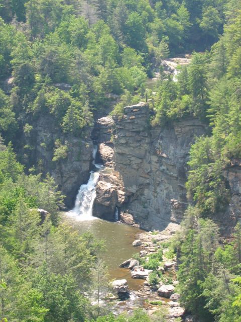 1985 Ford LTD Crown Victoria - A scenic view of a waterfall in a lush, forested mountain area.