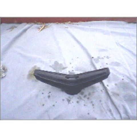 1972 Ford Ranchero - This is a black plastic car part lying on a white tarp.
