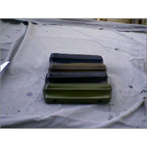 1972 Ford Ranchero - Several car bumpers are stacked on top of each other on a white cloth.