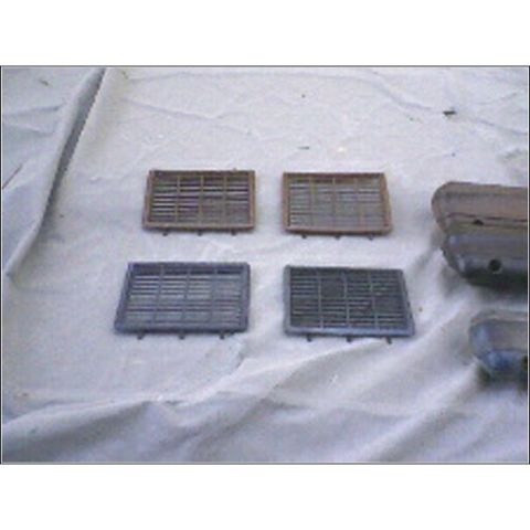1972 Ford Ranchero - Four vent grilles and a fender part are laid out on a white cloth surface.