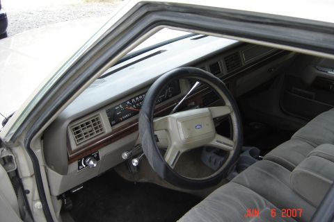 1989 Ford Crown Victoria LTD - The interior of a 1989 Ford Crown Victoria LTD, with a focus on the dashboard and seating.