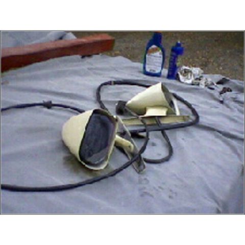 1972 Ford Ranchero - Two side mirrors, likely for a classic car, are laid out on a tarp with cleaning supplies nearby.