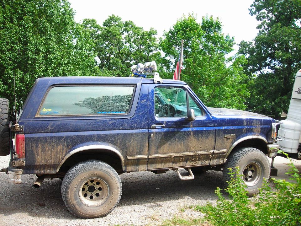 Mud-covered blue 1994 Ford Bronco parked outdoors