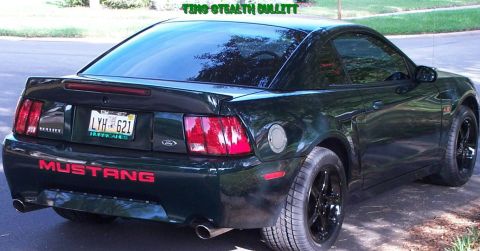 2001 Ford Mustang - Rear view of a dark green 2001 Ford Mustang with red lettering on the bumper.