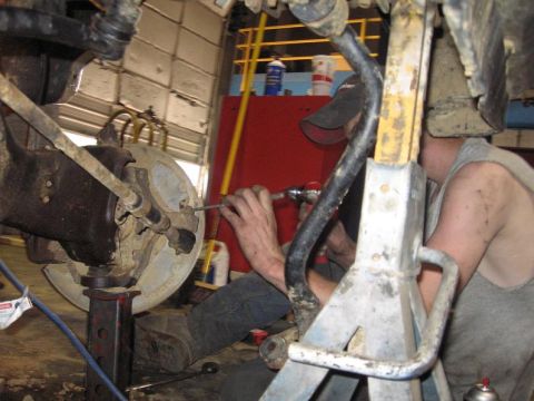 1988 Ford Bronco - my friend workin on it..my snap-on tool box in the back ground, and a bottle of DOT 3 brake fluid
