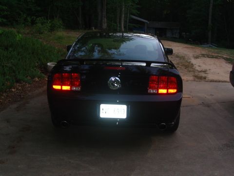 2007 Ford Mustang - Rear view of a black 2007 Ford Mustang, showing its distinctive taillights and license plate.