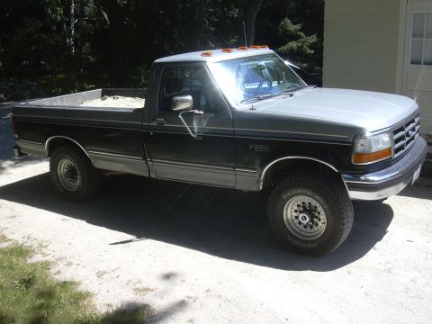 1992 Ford F-250 - This 1992 Ford F-250 pickup truck is shown from a three-quarter front angle, highlighting its two-tone paint scheme.