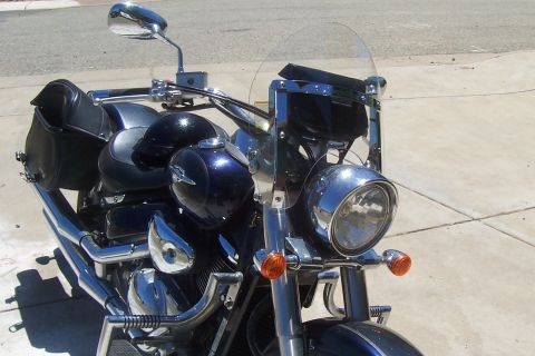 1994 Ford F-150 - A dark blue motorcycle with chrome accents and saddlebags is parked outdoors.
