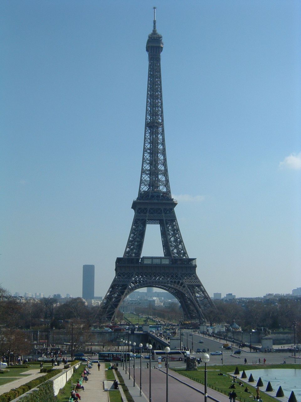 Eiffel Tower in Paris with a cityscape and some people in the foreground
