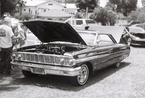 1973 Ford Ranchero - This 1964 Ford Galaxie 500 is displayed with its hood open, revealing the engine and custom wheels.