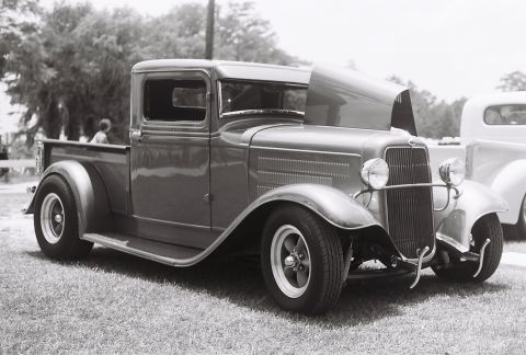 1973 Ford Ranchero - Customized 1932 Ford pickup truck, likely a hot rod, displayed outdoors with its hood up.