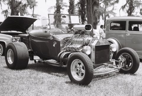 1973 Ford Ranchero - A heavily modified roadster with a large engine sits on display at an outdoor event.