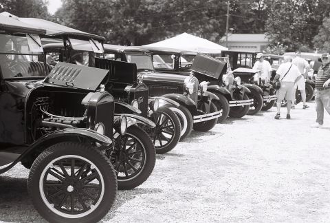 1973 Ford Ranchero - Multiple vintage Ford Model T cars are lined up, some with hoods open, at an outdoor gathering.