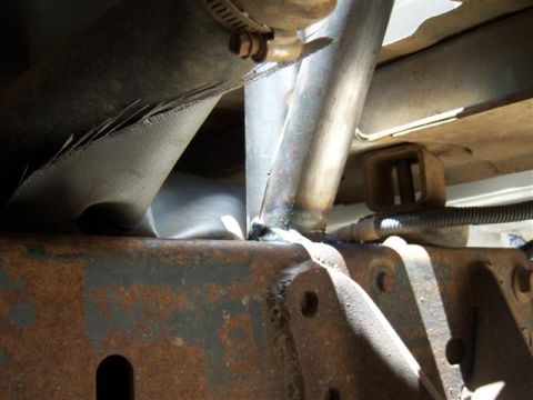 1995 Ford Bronco - Underside view of a vehicle's frame and exhaust system, with visible rust and metalwork.
