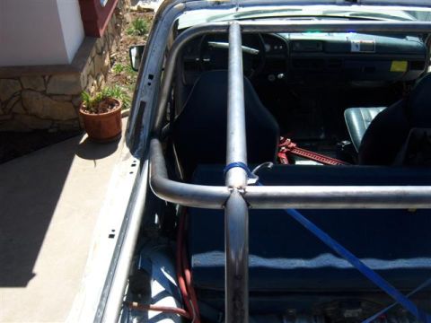 1995 Ford Bronco - Interior view of a 1995 Ford Bronco showing the roll cage and dashboard.