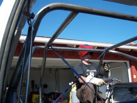 1995 Ford Bronco - Welder installs a custom roll cage, likely for off-road use.