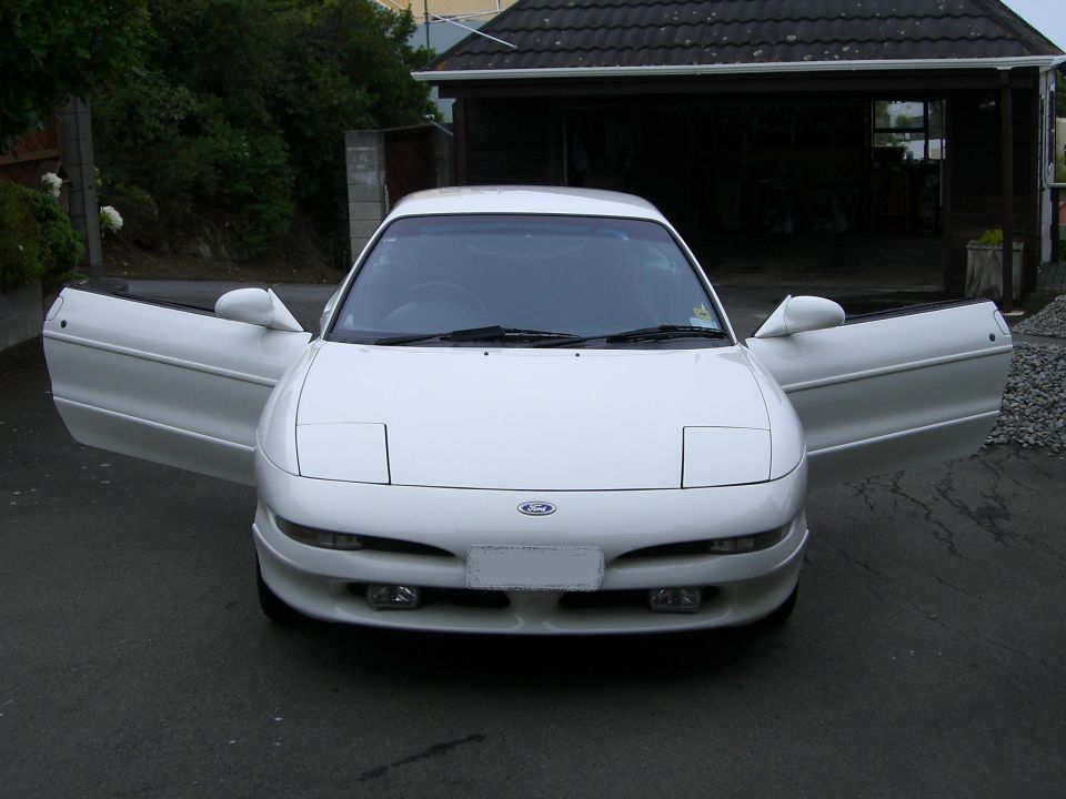 White Ford Probe with doors open, front view. The car appears to be in good condition