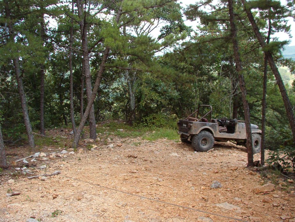 Trash on the trail!  Our entrance to the Rubicon was blocked by this abandoned Heep, whose LHF steering knuckle was no longer attached to the axle housing.  We did him the favor of pulling it back up to level ground.  Unfortunately, his LHR tire came off the rim in the process, and the LHF tie rod end separated.  Sorry, but I doubt he could have gotten it out of there in any better condition.