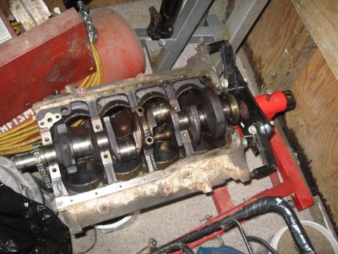 1988 Ford Bronco - Engine block assembly on a stand, showing internal components like the crankshaft and connecting rods.