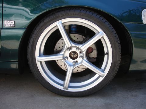 1993 Ford Taurus - Close-up of a car's wheel and fender, a '24V DOHC' badge.