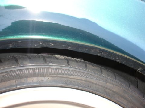1993 Ford Taurus - A close-up view of a vehicle's tire and fender liner, showing tire size information.