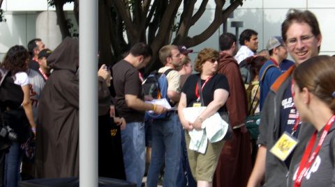 1990 Ford Probe - A crowd of people, some in costume, are gathered outdoors, possibly at an event or convention.