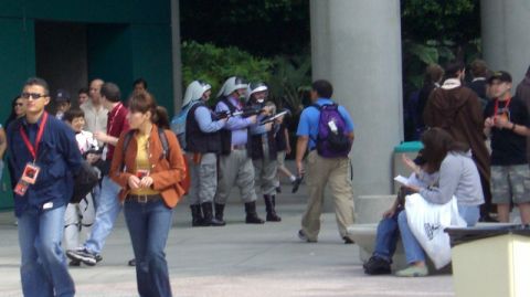 1990 Ford Probe - A group of people dressed in costumes, some with helmets and prop weapons, are gathered outdoors.