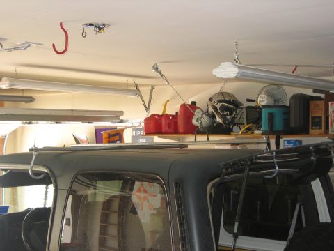 2001 Jeep Wrangler - A view inside a vehicle, looking up at shelves filled with various items in a garage setting.