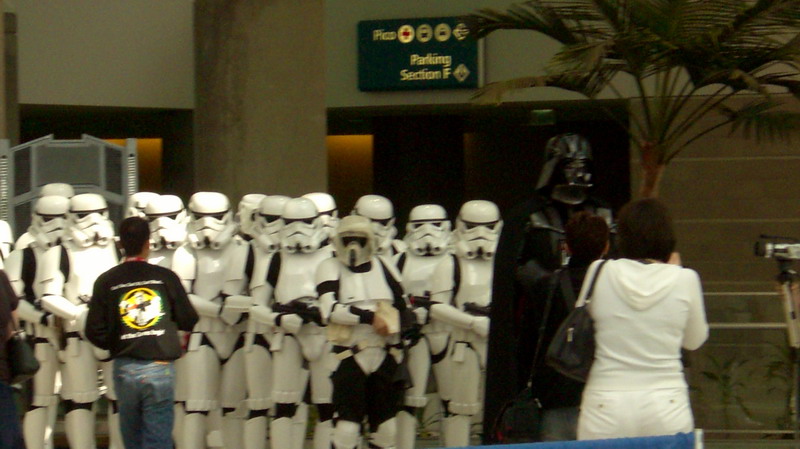 Group of Stormtroopers and Darth Vader in costume, with a sign for Parking Section F