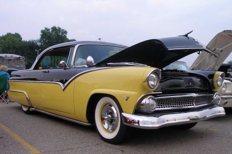 1998 Ford Crown Victoria - A classic two-tone yellow and black 1955 Ford Fairlane Crown Victoria is displayed with its hood open.