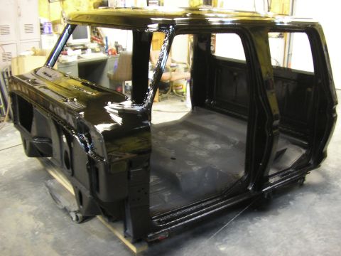 1979 Ford F-350 - This black truck cab, possibly a 1973 Ford F-Series, is undergoing restoration in a workshop.