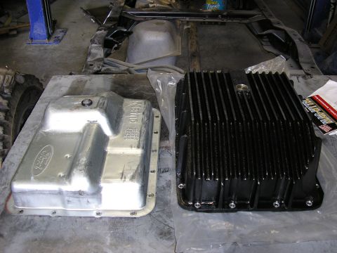 1979 Ford F-350 - Comparison of a silver Ford oil pan and a black finned oil pan in a garage setting.