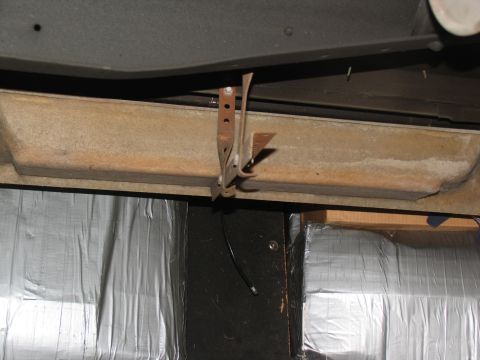 1995 Ford C-150 (Centurion Conversions) - Close-up view of a running board mounting bracket attached to the vehicle's frame.
